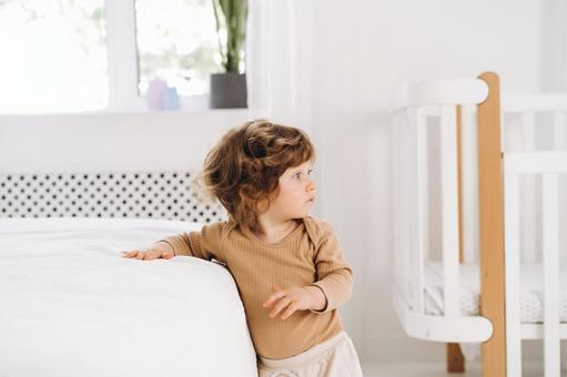 ベッドに手をつき振り向く子 ベッドに手をつき振り向く子の写真