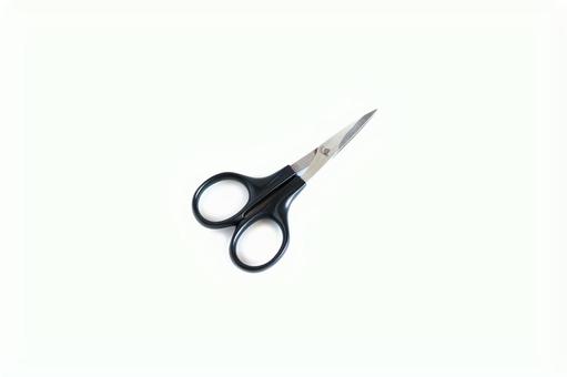 刃先が閉じた黒い持ち手の小さいハサミ 刃先が閉じた黒い持ち手の小さいハサミの写真
