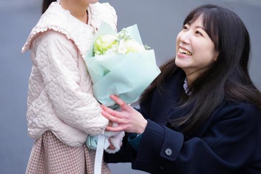 女の子に花束を渡す女性 女の子に花束を渡す女性 女性,人物,ロングヘアの写真素材