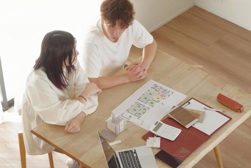 営業マンと家づくりの相談をする若い夫婦 営業マンと家づくりの相談をする若い夫婦 住宅,家,新築の写真素材