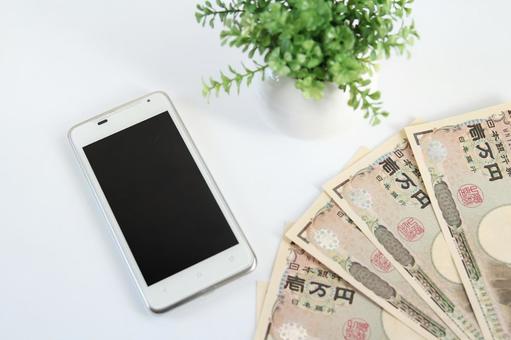 スマホと日本円の現金 スマホと日本円の現金の写真
