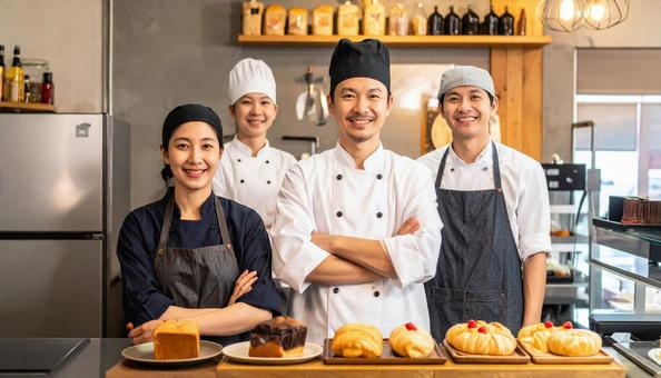 ケーキ屋の厨房のコックコート姿のシェフの写真