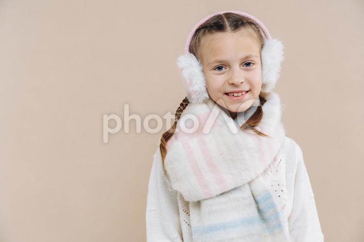 イヤーマフ・マフラーを身に着けた笑顔の女の子 冬,女の子,外国人の写真素材