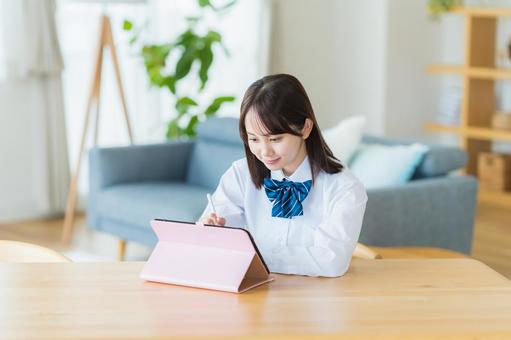 タブレットで勉強する女子高生 タブレットで勉強する女子高生 高校生,タブレット,笑顔の写真素材
