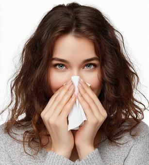 アレルギーに悩む女性の表情の写真