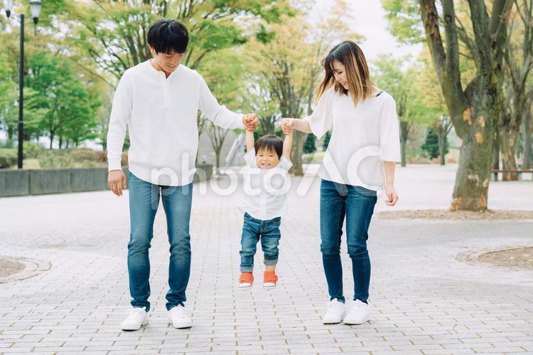 手を繋いで歩く家族（ジャンプ） 子供,赤ちゃん,子育ての写真素材