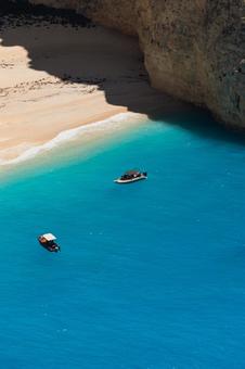 A small boat floating on the blue sea, JPG A small boat floating on the blue sea, JPG