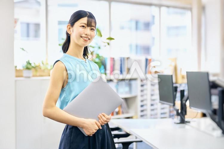 キャリアウーマン　ノートパソコン　持つ　 ビジネスウーマン,笑顔,若いの写真素材