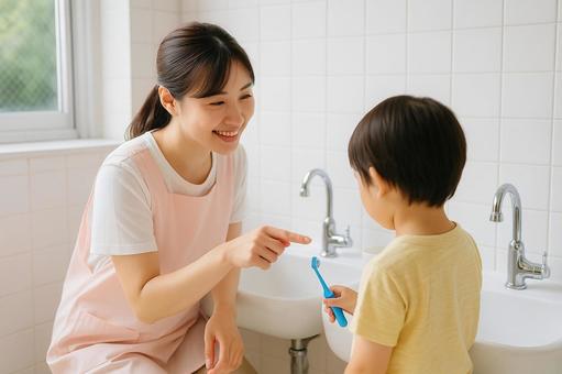 保育士の歯磨き指導風景 保育士の歯磨き指導風景の写真