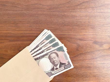 机に置かれた茶封筒に入った紙幣 お金,紙幣,封筒の写真素材