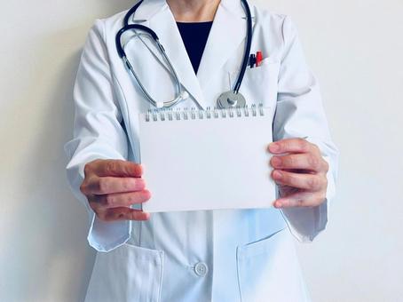 A female doctor holding a blank spiral notebook, JPG A female doctor holding a blank spiral notebook, JPG
