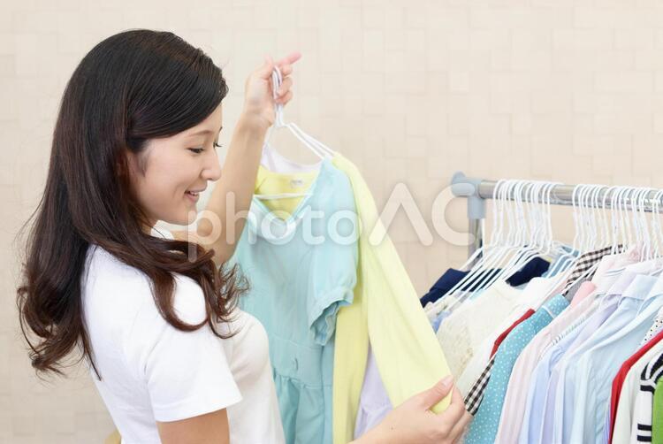 衣類を選ぶ女性 女性,女,笑顔の写真素材