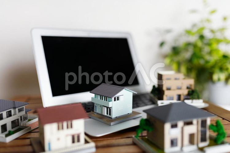 ノートパソコンと住宅模型 住宅,ビジネス,不動産の写真素材