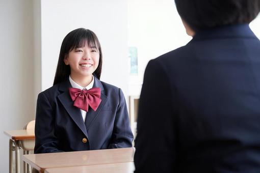 Japanese female junior high school student having an interview with a teacher in the classroom, студент средней школы, женщина, японский, JPG