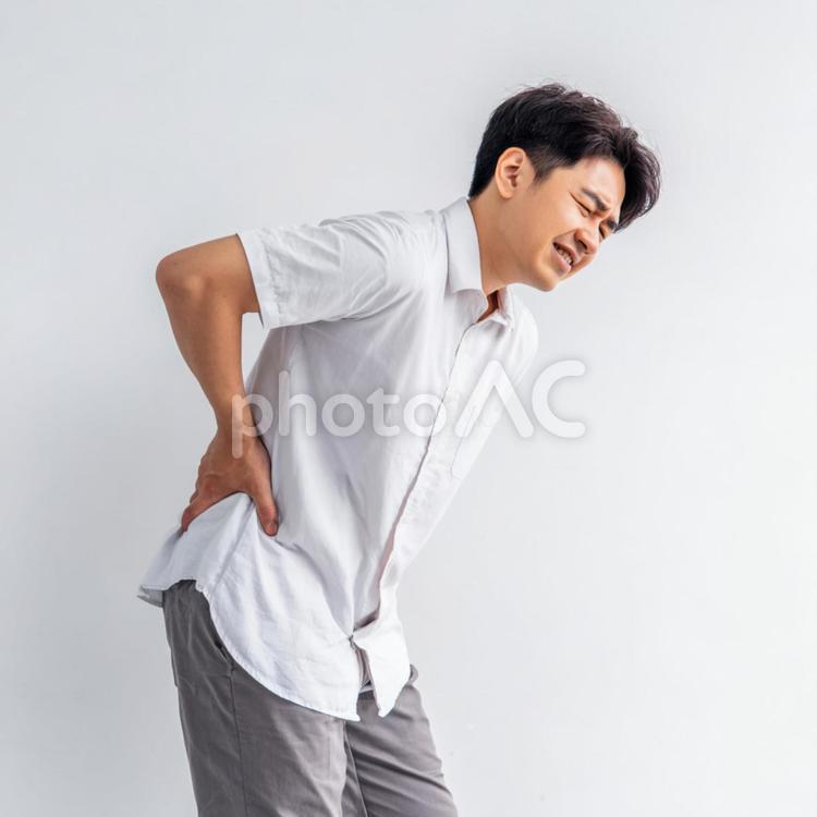 腰を痛めた男性 腰,腰痛,痛みの写真素材