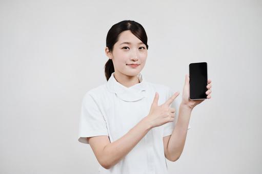 A woman in a white coat operating a smartphone A woman in a white coat operating a smartphone