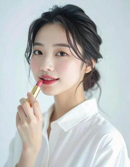 リップを塗る若い女性の美容ポートレート リップを塗る若い女性の美容ポートレートの写真