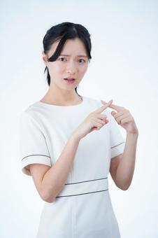 女性が指をバツを出して説明する 女性,バツ,ダメの写真素材