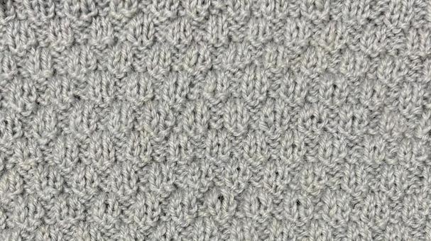 ニットグレー 手編み,編み目,テクスチャの写真素材