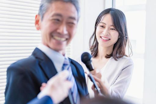 A female announcer conducting an interview, JPG
