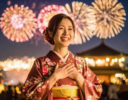 花火を見て感動する浴衣姿の女性（夏祭り）の写真