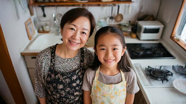 キッチンに立つ母と娘2 キッチンに立つ母と娘2の写真