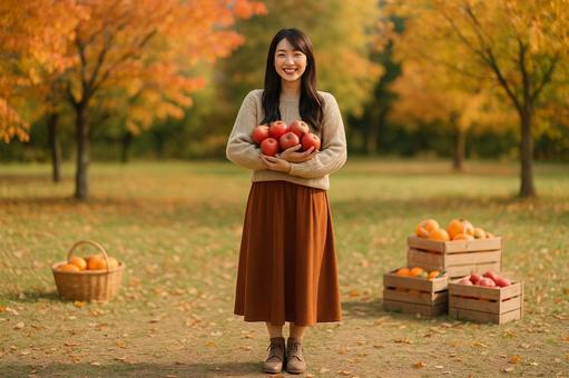 秋の実りを抱く女性 秋の実りを抱く女性の写真