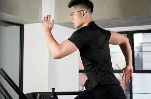 Asian man running on a treadmill in a training gym Asian man running on a treadmill in a training gym