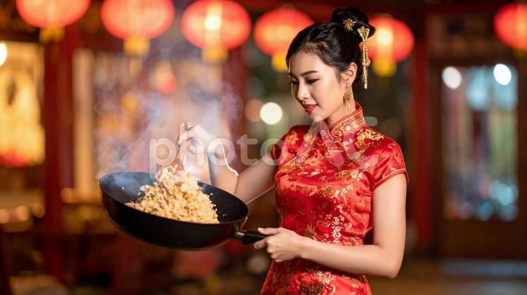 チャーハンがうまくできて満足そうな女性 女性,チャーハン,チャイナ服の写真素材