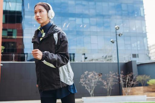 A woman jogging in an office district, JPG A woman jogging in an office district, JPG