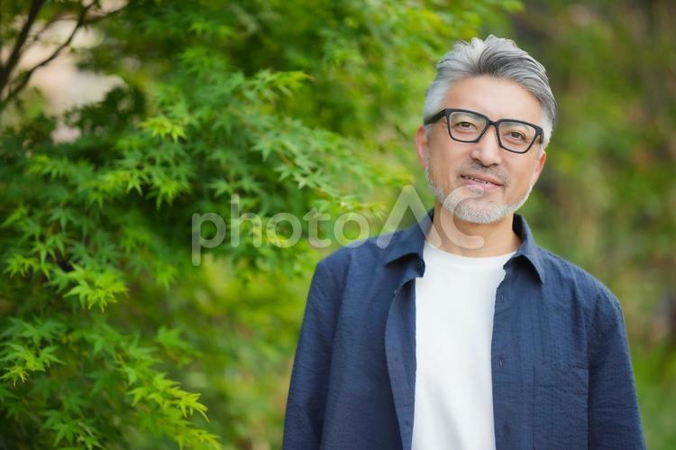 自然の中でカメラ目線の男性のアップ 男性,シニア,働くの写真素材