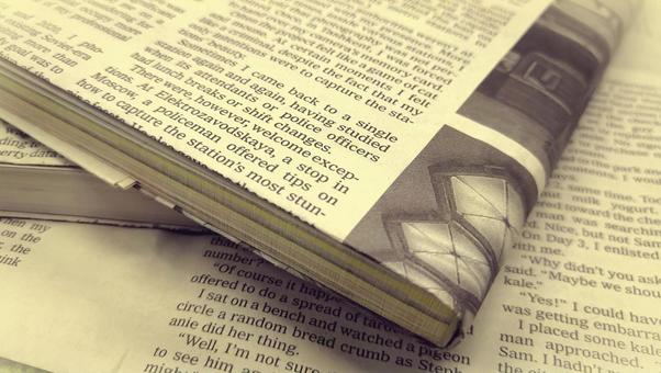英字新聞のブックカバーをつけた書籍 英字新聞のブックカバーをつけた書籍の写真