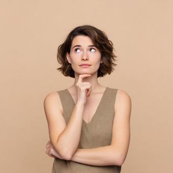 何かを思案する、輝く肌の若い女性 何かを思案する、輝く肌の若い女性の写真