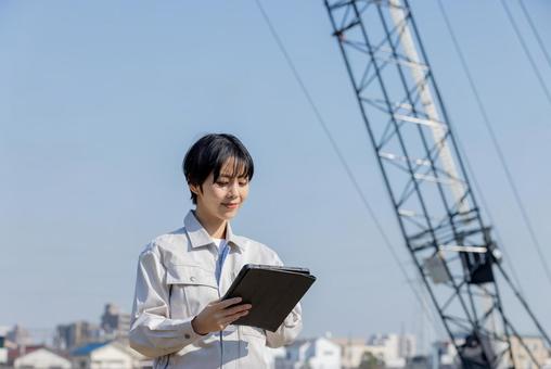 Woman in work clothes at a construction site, JPG