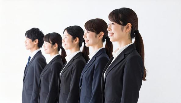 斜めの角度から見た整列する若い会社員の写真