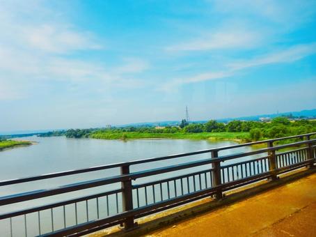 A view of the tranquil Shinano River and bridges from the train window, JPG A view of the tranquil Shinano River and bridges from the train window, JPG