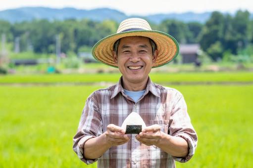 Japanese man eating rice balls in front of a rice field, agriculture, male, rice field, JPG