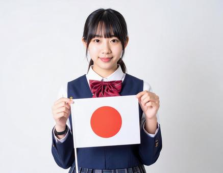 日の丸の国旗を持った女子生徒のイメージ 日の丸の国旗を持った女子生徒のイメージの写真