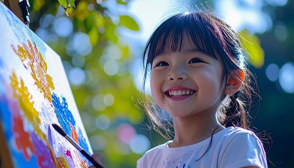 ペインティング中の日本人の子どもの笑顔 ペインティング中の日本人の子どもの笑顔の写真