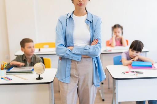 生徒の前で腕を組んでいる女性 鼻から下,女性,女の子の写真素材