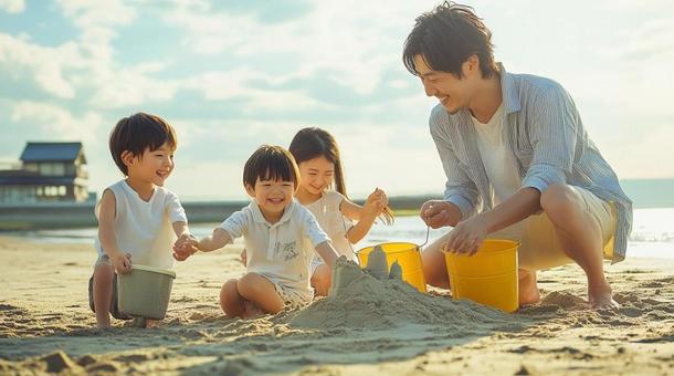 海辺で砂遊びをする家族の写真