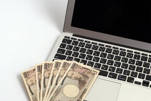 パソコンと一万円札 パソコンと一万円札 パソコン,ノートパソコン,キーボードの写真素材