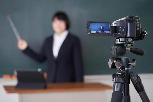 Japanese female teacher shooting online lessons in the classroom Japanese female teacher shooting online lessons in the classroom