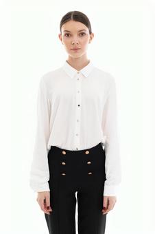 Woman in white shirt looking at camera with straight face, JPG