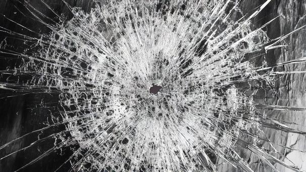 弾痕が残る割れたガラスの背景画像 弾痕が残る割れたガラスの背景画像の写真