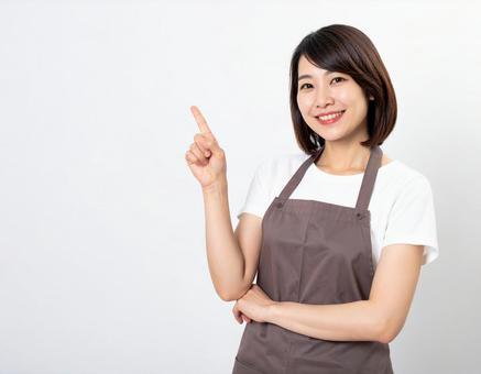 笑顔で指さす30代の日本人女性 笑顔で指さす30代の日本人女性の写真