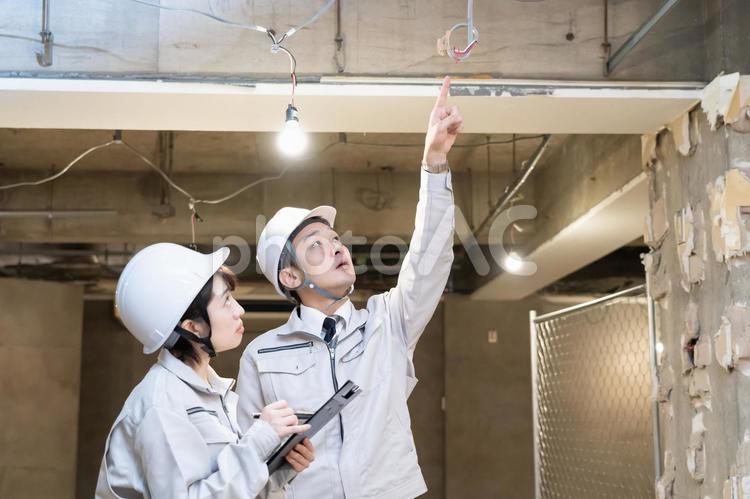 確認する作業着を着た男女 女性,ビジネス,建築現場の写真素材