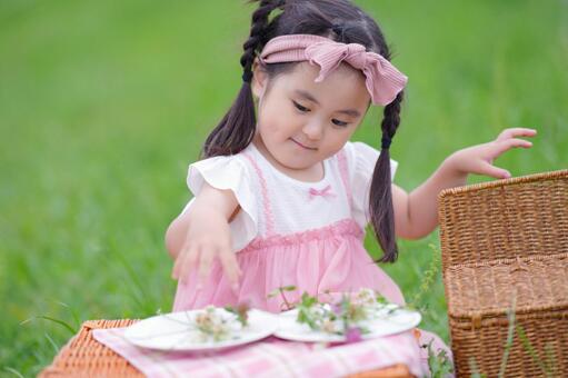 ピクニックバスケットの前で夢中に遊ぶ子供 女の子,バスケット,ピクニックの写真素材
