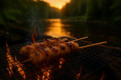 川辺の焚き火で滴る肉汁が香る焼き鳥 川辺の焚き火で滴る肉汁が香る焼き鳥の写真