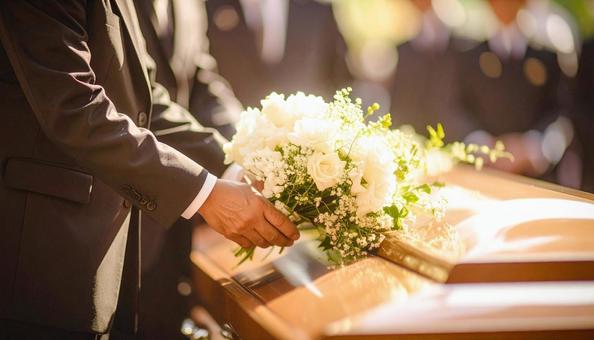 葬式でお棺に白い花束を捧げる人の手もと 葬式でお棺に白い花束を捧げる人の手もとの写真